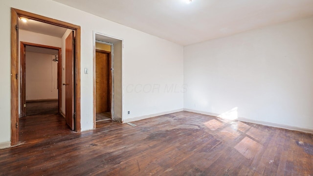 spare room with dark hardwood / wood-style flooring