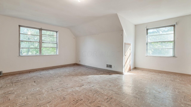 additional living space featuring lofted ceiling