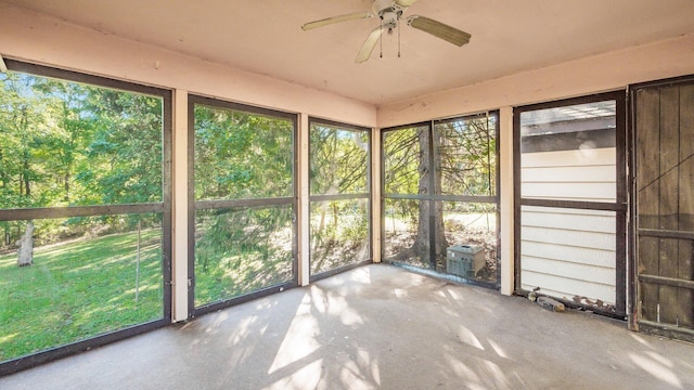 unfurnished sunroom featuring ceiling fan