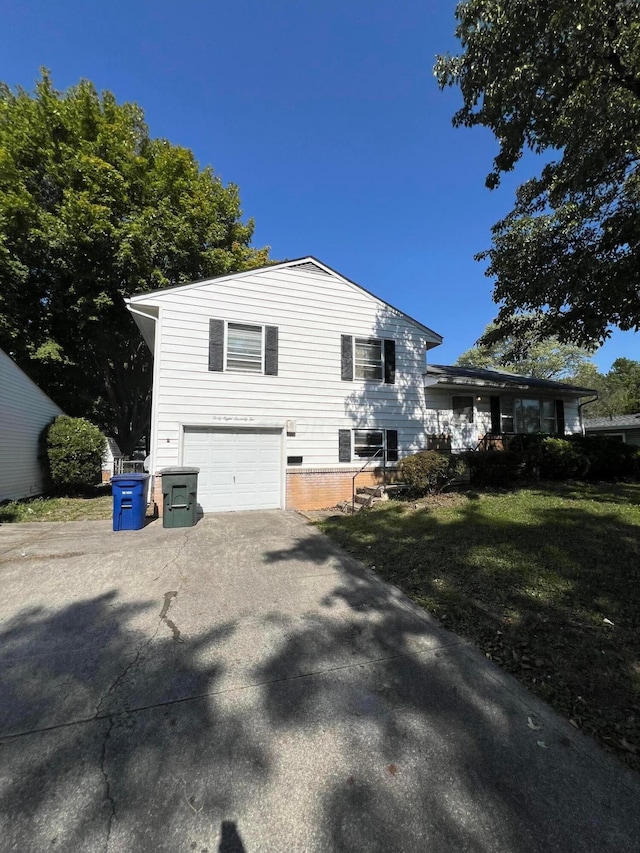 view of side of property featuring a garage and a yard