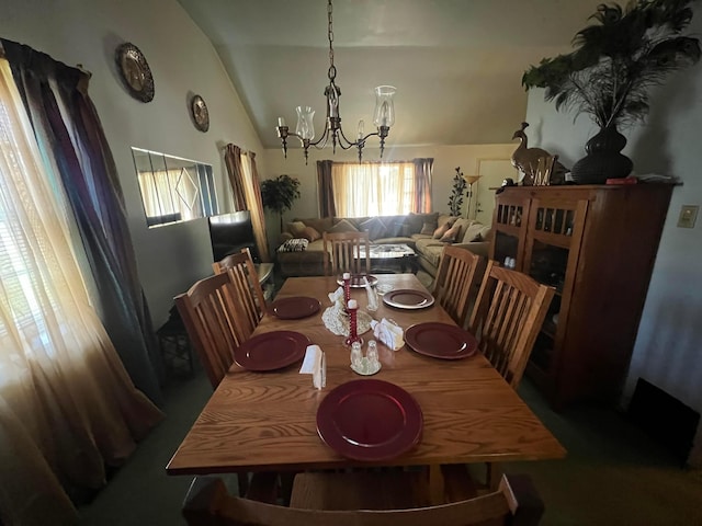 dining room with an inviting chandelier and vaulted ceiling