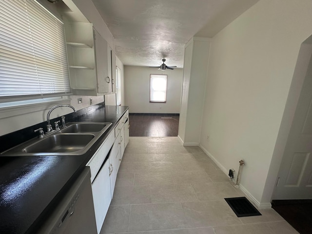 kitchen featuring ceiling fan, sink, white cabinets, and white dishwasher