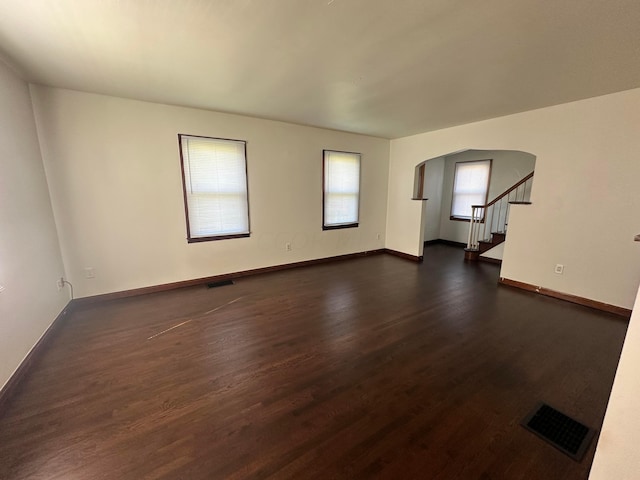 unfurnished room with dark hardwood / wood-style floors