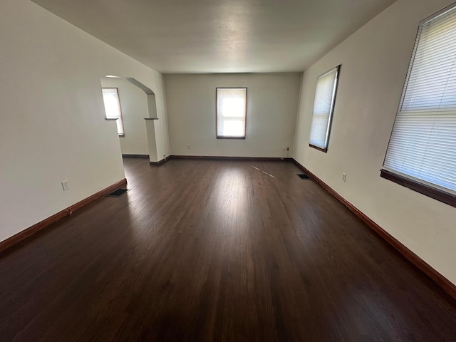 spare room featuring dark wood-type flooring