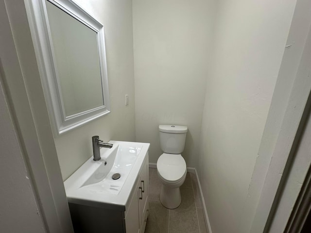 bathroom featuring tile patterned flooring, vanity, and toilet