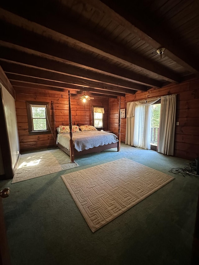 unfurnished bedroom with beamed ceiling, carpet flooring, wooden walls, and multiple windows