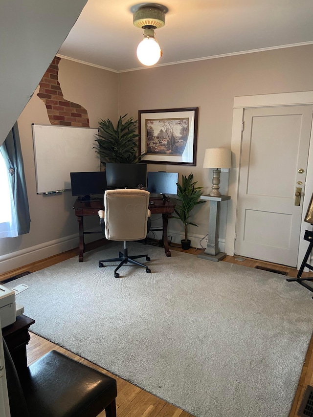 office area with light hardwood / wood-style flooring and ornamental molding