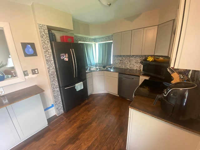 kitchen with backsplash, dark hardwood / wood-style flooring, white cabinets, and appliances with stainless steel finishes