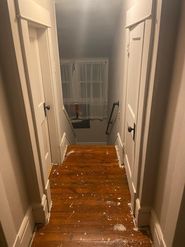 hallway with dark hardwood / wood-style flooring