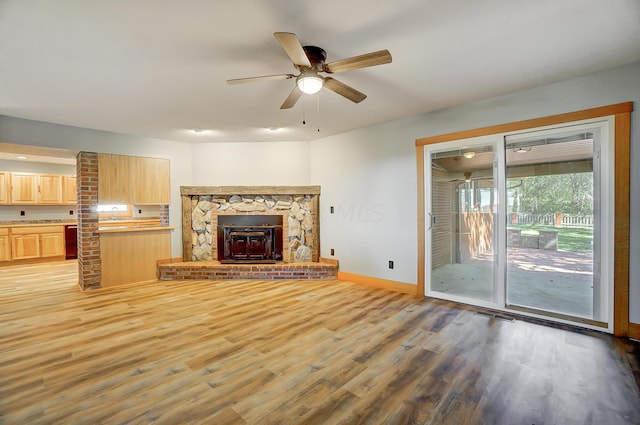 unfurnished living room with hardwood / wood-style floors and ceiling fan