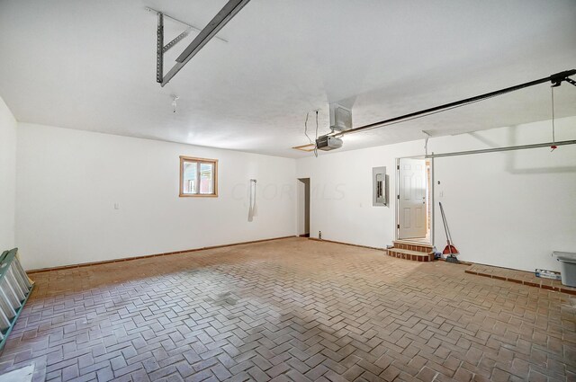 garage with electric panel and a garage door opener