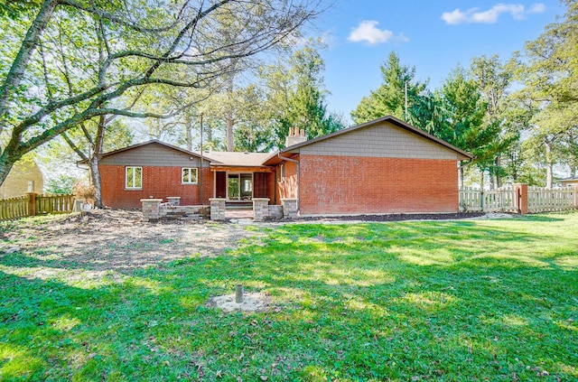 rear view of house with a lawn