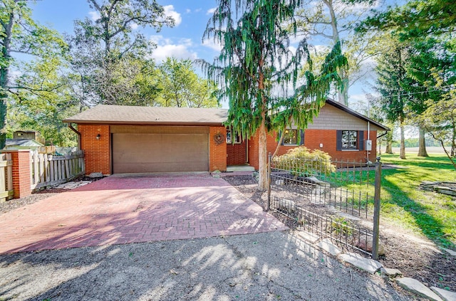 single story home with a garage and a front yard