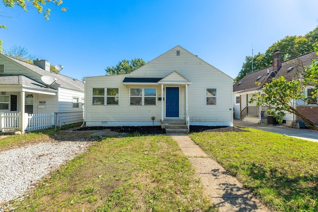 bungalow-style home featuring a front lawn