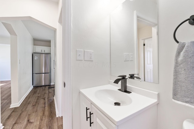 bathroom with hardwood / wood-style flooring and vanity