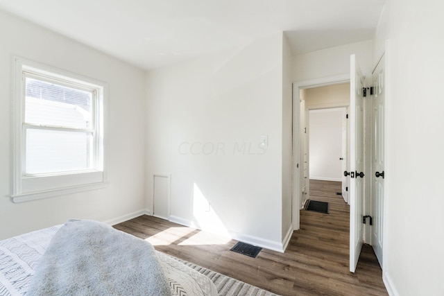 unfurnished bedroom featuring dark wood-type flooring