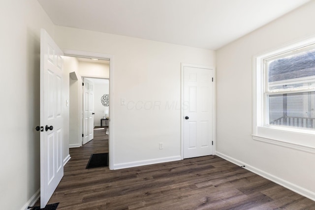 unfurnished bedroom with dark wood-type flooring