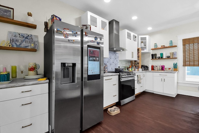 kitchen featuring decorative backsplash, appliances with stainless steel finishes, dark hardwood / wood-style flooring, wall chimney exhaust hood, and white cabinetry