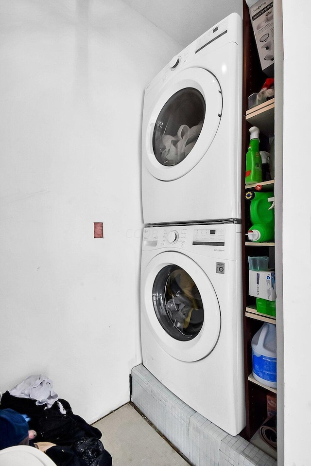 clothes washing area with stacked washer / drying machine