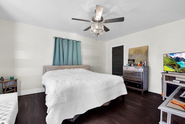 bedroom with dark hardwood / wood-style flooring and ceiling fan