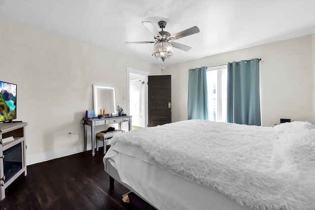 bedroom with ceiling fan and dark hardwood / wood-style flooring