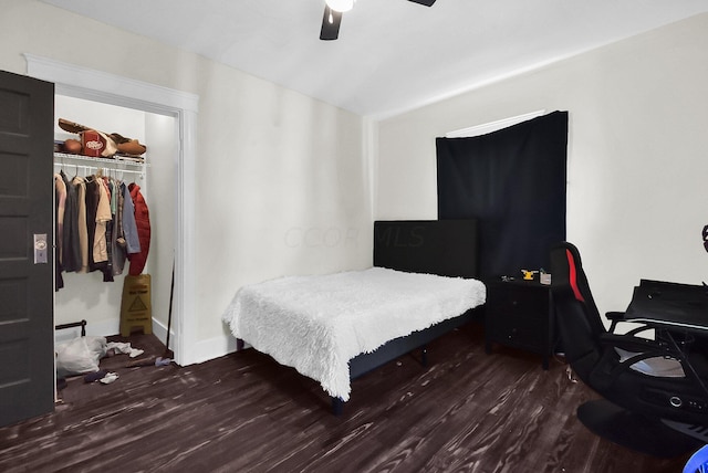 bedroom with dark hardwood / wood-style flooring, a closet, and ceiling fan