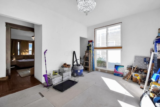 misc room with light hardwood / wood-style floors and an inviting chandelier