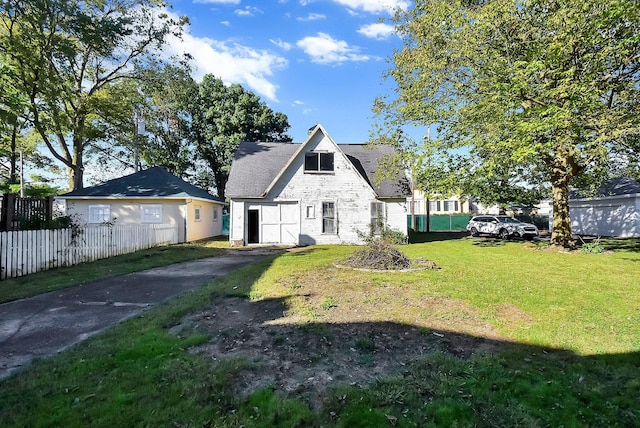 rear view of property with a yard