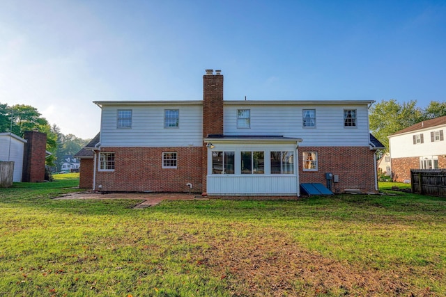 back of house featuring a lawn