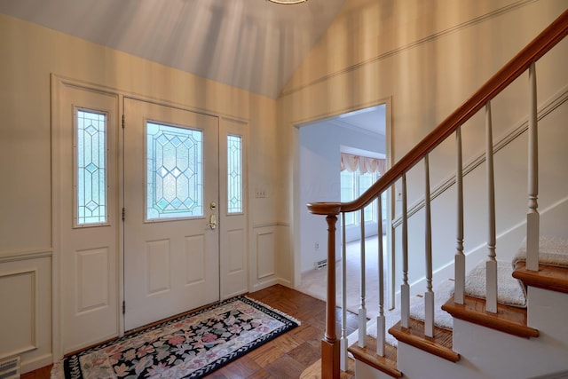 foyer entrance featuring crown molding and light parquet flooring