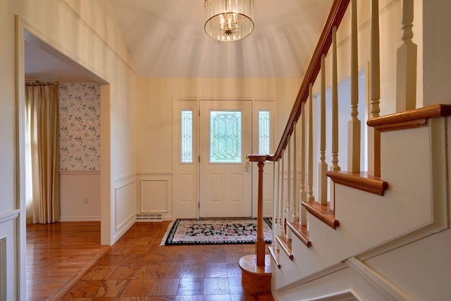 entryway with hardwood / wood-style floors and an inviting chandelier