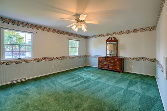 spare room with ceiling fan and carpet floors