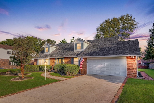 cape cod-style house with a yard and a garage