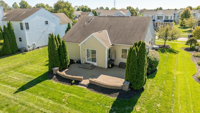 back of property featuring a yard and a patio area