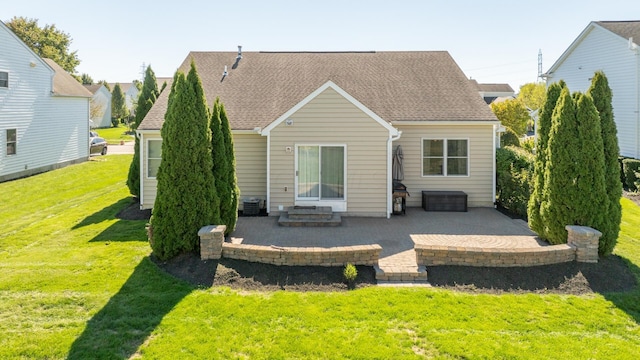 rear view of property featuring a patio area and a yard