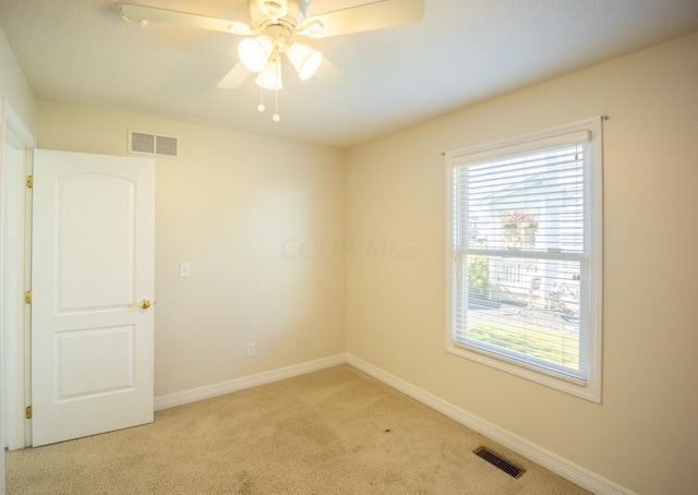 empty room with light colored carpet and ceiling fan