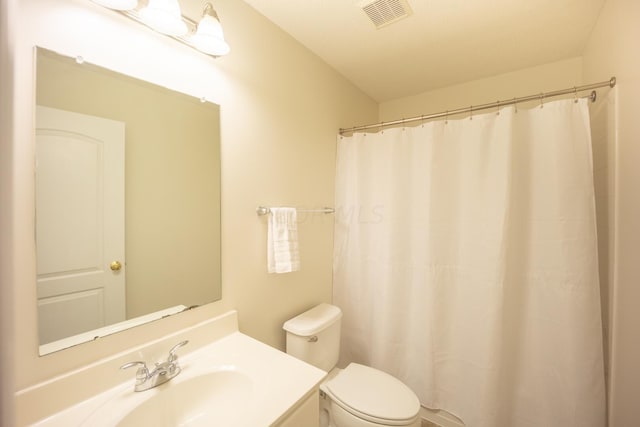 bathroom with vanity, toilet, and walk in shower