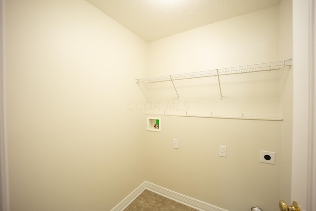 laundry area featuring hookup for an electric dryer, washer hookup, and a textured ceiling