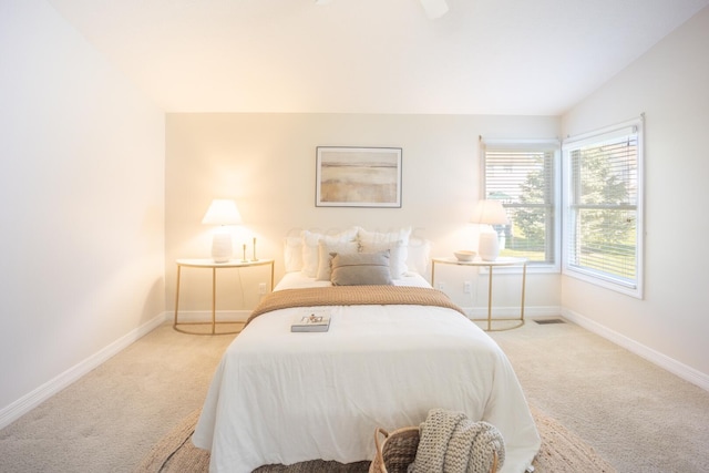 carpeted bedroom featuring lofted ceiling