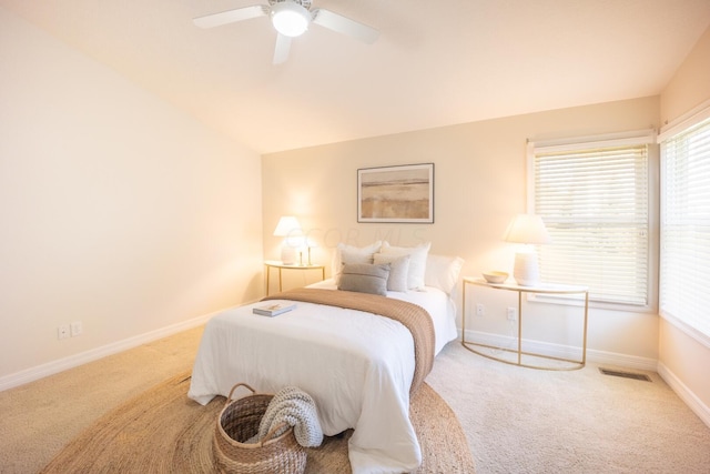 carpeted bedroom with vaulted ceiling and ceiling fan