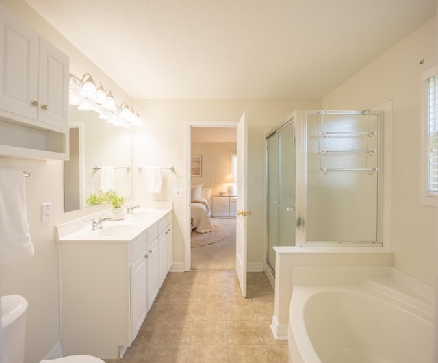 bathroom with tile patterned flooring, vanity, and plus walk in shower