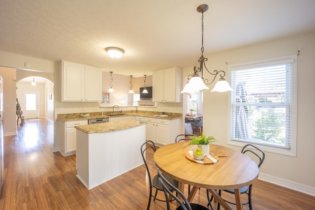 kitchen featuring plenty of natural light and white cabinetry