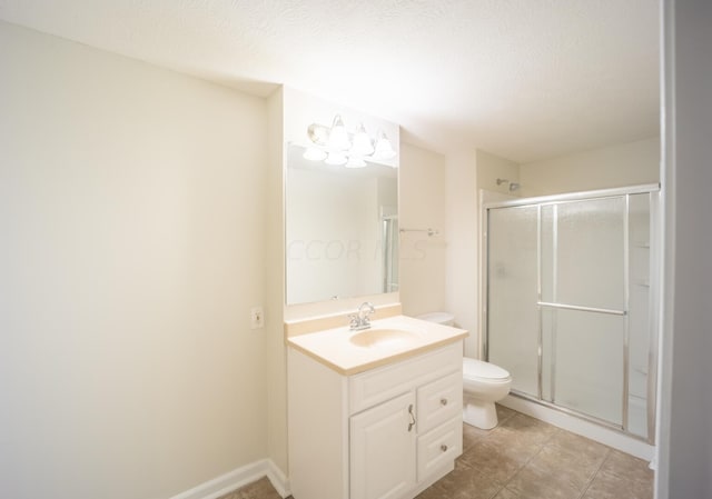 bathroom featuring a textured ceiling, vanity, toilet, and an enclosed shower