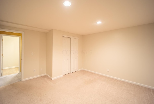 unfurnished bedroom with carpet floors and a closet