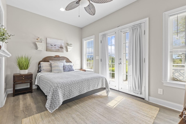 bedroom with access to outside, ceiling fan, hardwood / wood-style floors, and french doors