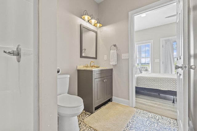 bathroom featuring hardwood / wood-style floors, vanity, and toilet