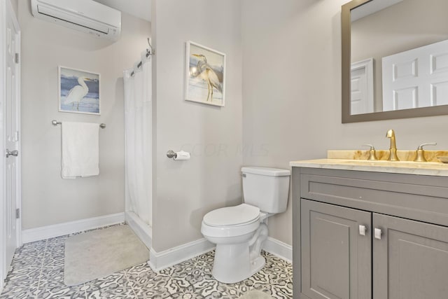 bathroom featuring toilet, tile patterned floors, vanity, and an AC wall unit