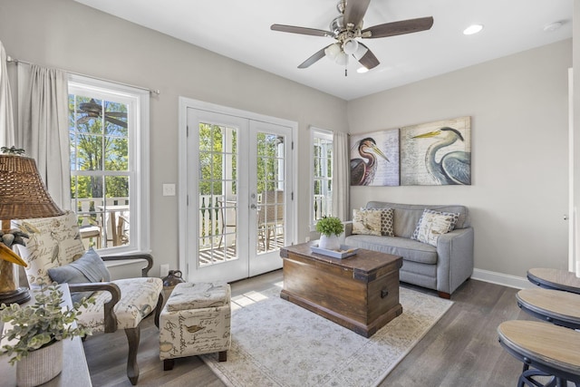 living room featuring french doors, dark hardwood / wood-style flooring, and ceiling fan