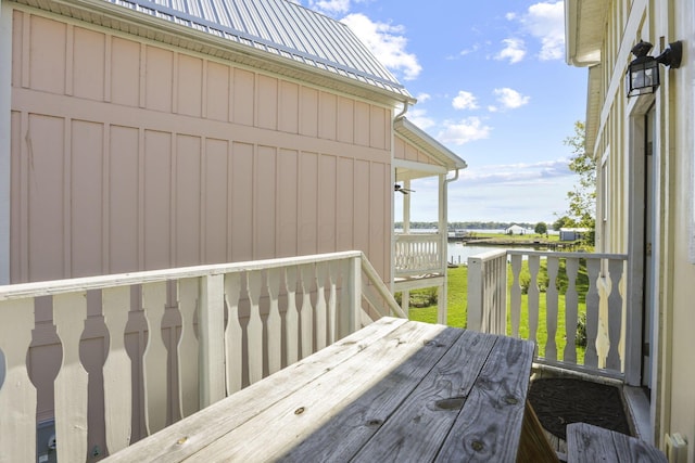 exterior space featuring a deck with water view