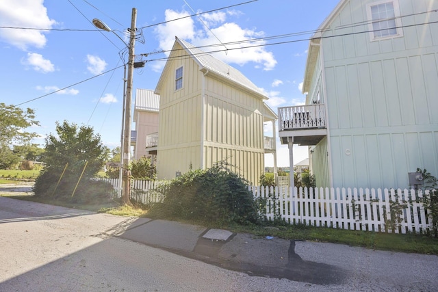 view of side of home with a balcony